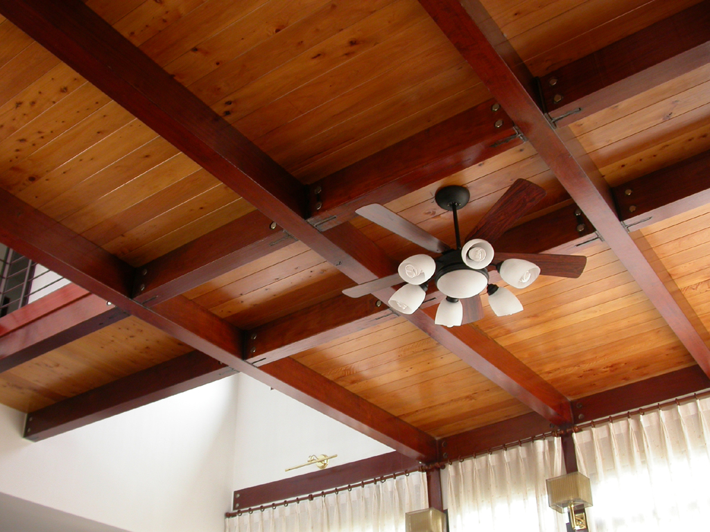 a ceiling fan with four white fans mounted to the side