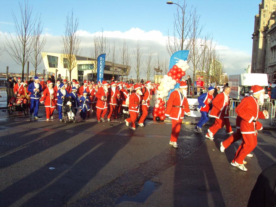 a bunch of people in red uniforms walking down the street