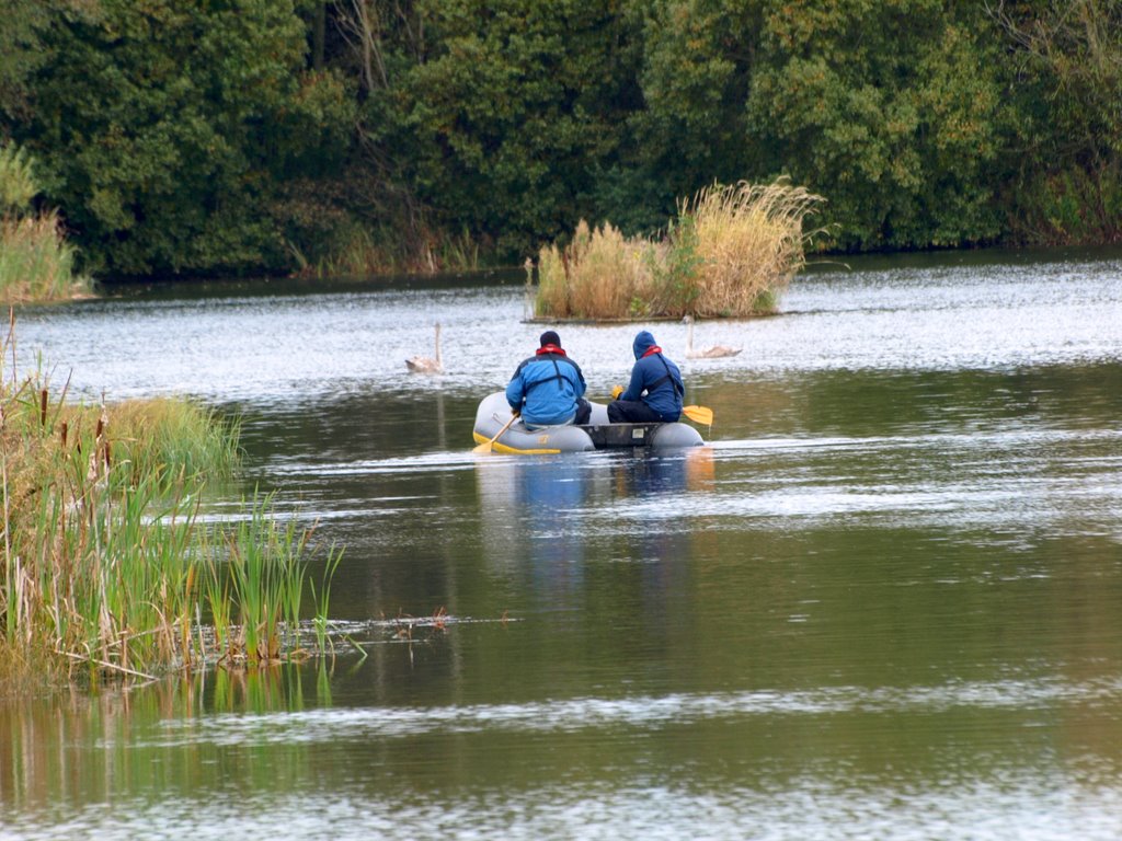 two people in an inflatable boat ride across the water