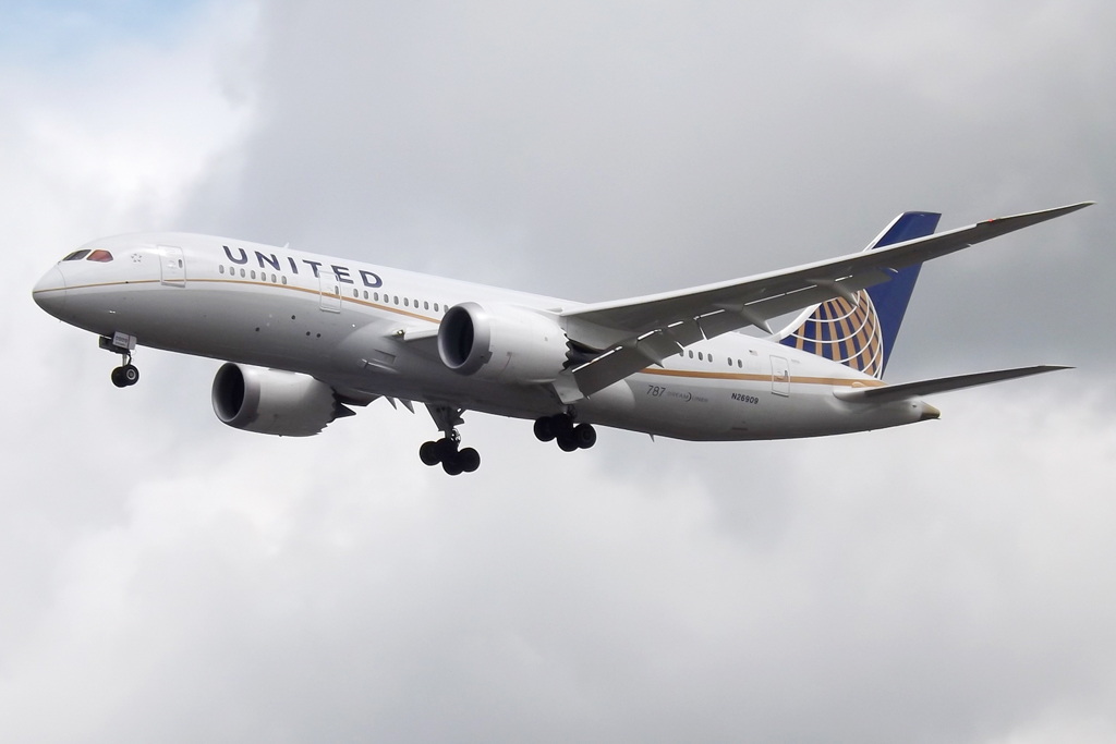 an airplane is flying in the cloudy sky