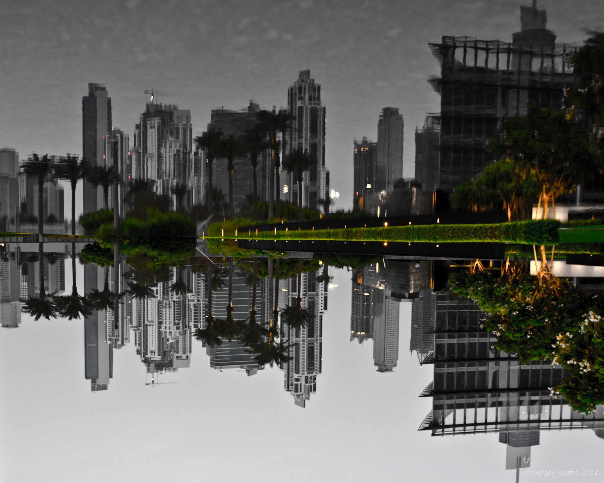 a picture taken in black and white looking down on buildings reflecting in the water