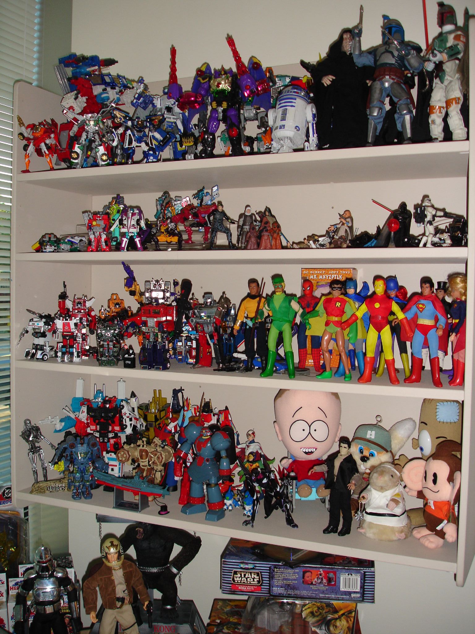 some shelves full of comic collectibles and toys