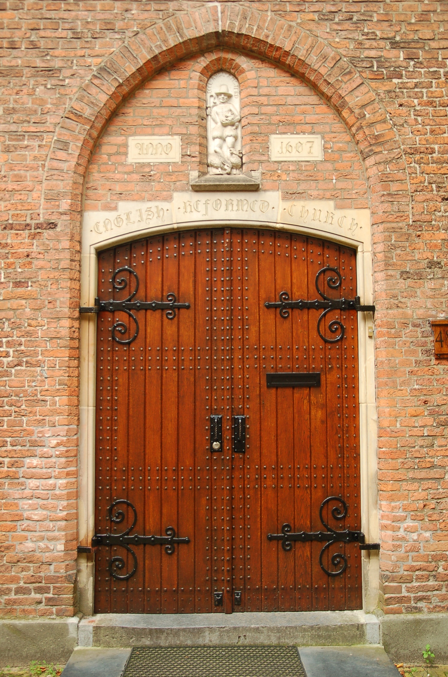a large gated doorway on a brick wall