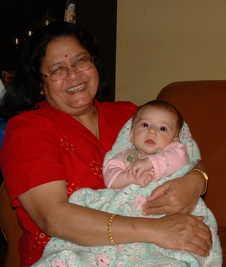 a woman holding a baby wrapped in blankets