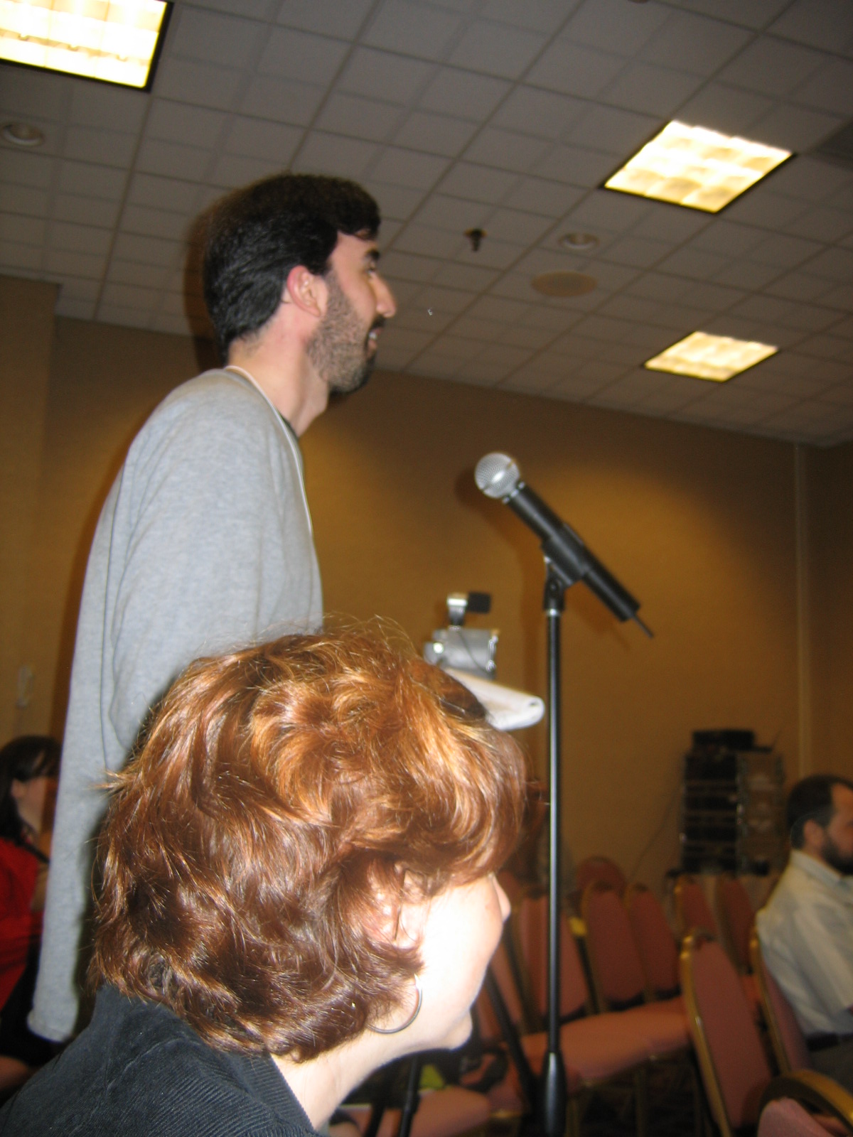 a man that is standing in front of a microphone