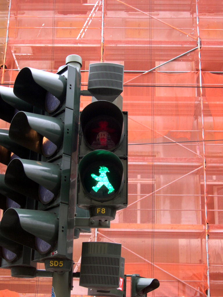 an green traffic light showing the green walk sign