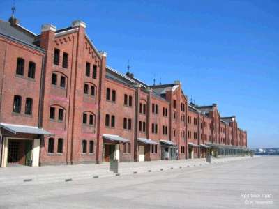 red brick building with multiple rows of windows on it