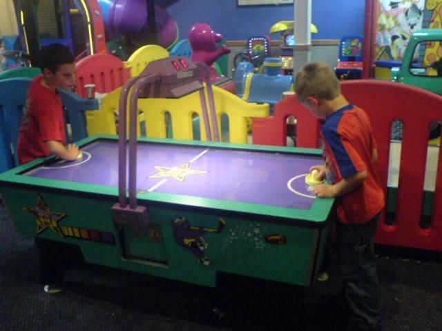 two boys playing with an interactive play center
