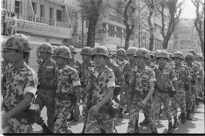 a group of soldiers marching through a street