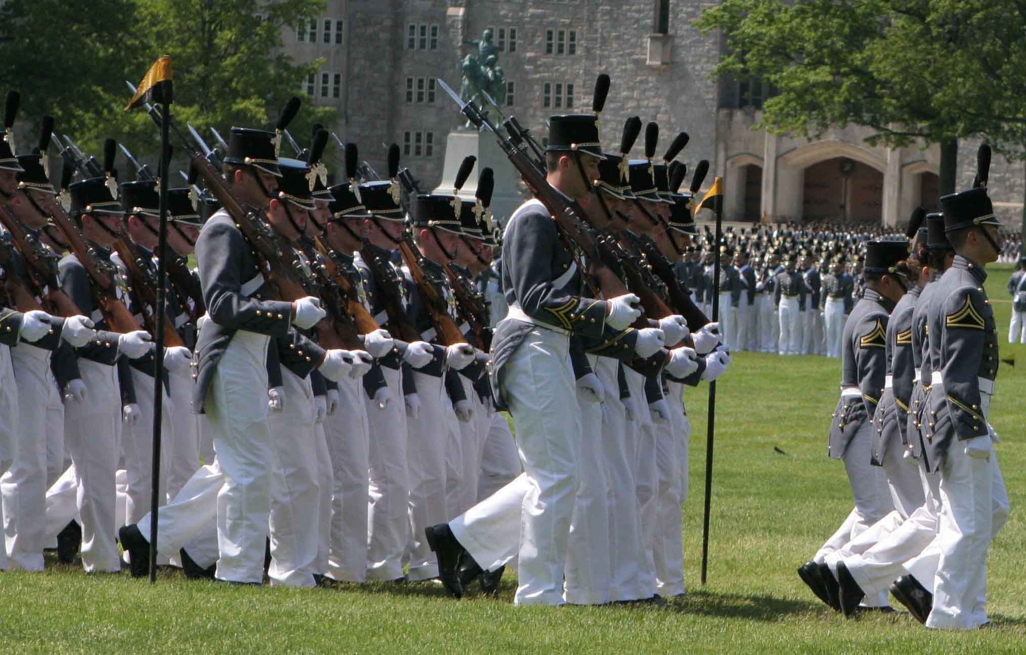 a military drill band performing in front of the palace