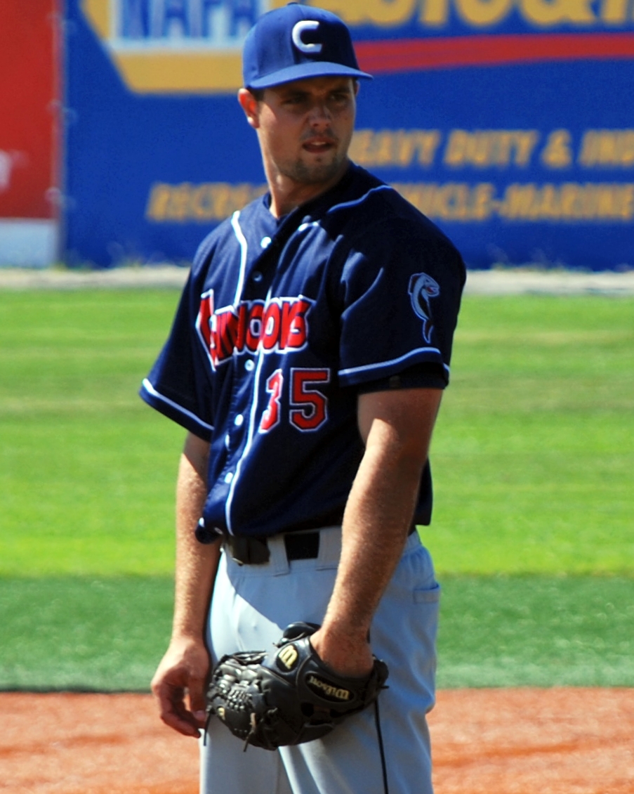 a man in a baseball uniform is standing on a field
