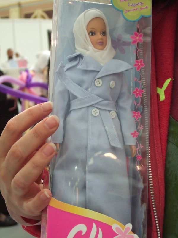 the barbie doll is wearing a very nice coat