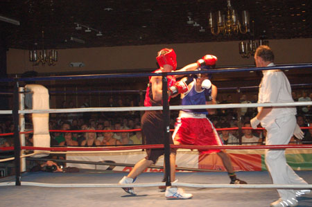 men on the rings boxing with a referee