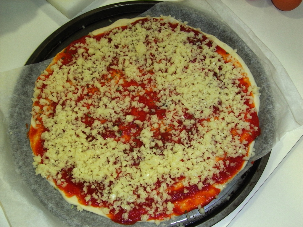 a freshly cooked pizza on a pan sitting on the table