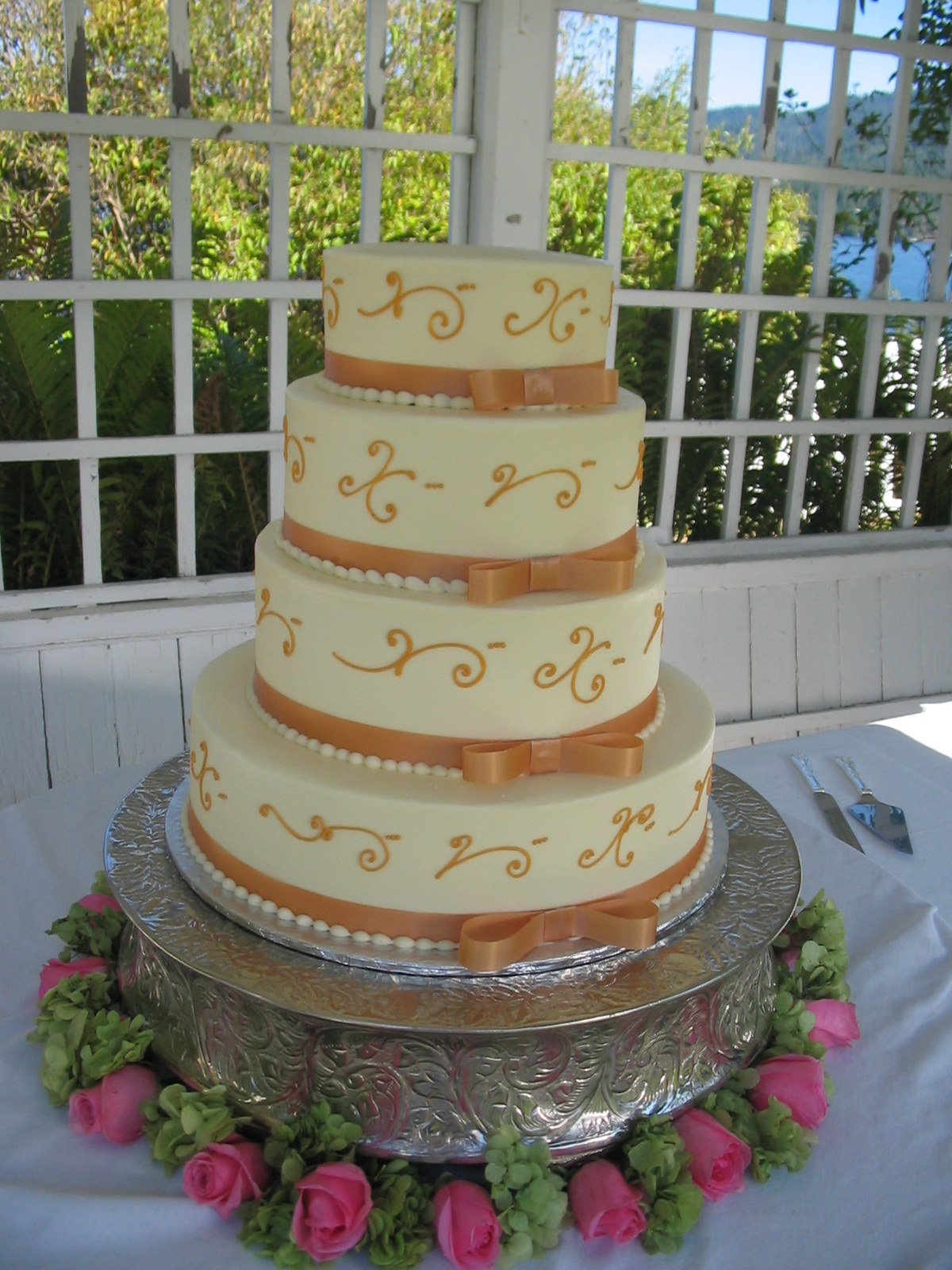 a four layer cake with brown ribbons