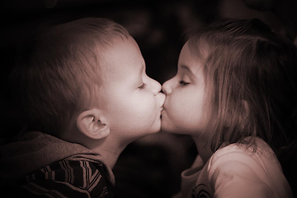a boy kissing a girl as they kiss