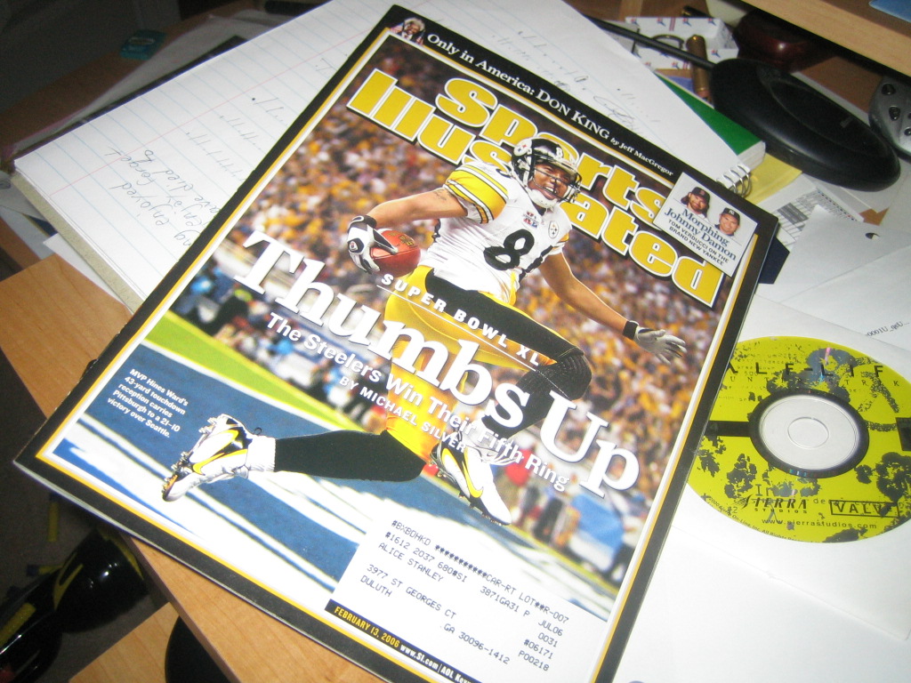 a po of a football player on a magazine next to a cd