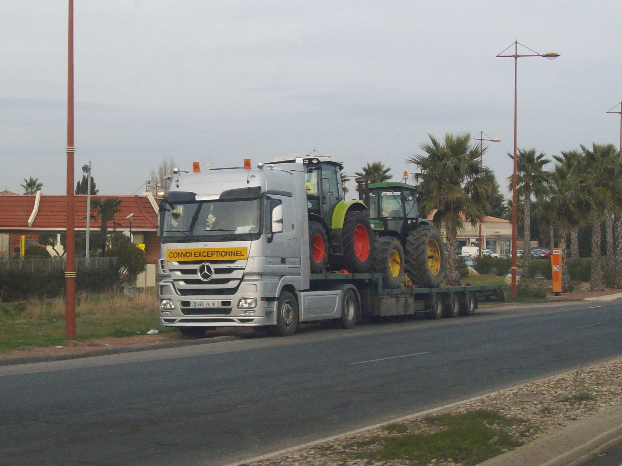 a tractor truck is parked on a street with a large trailer