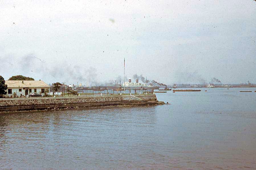 the smoke stacks are rising above the waterway