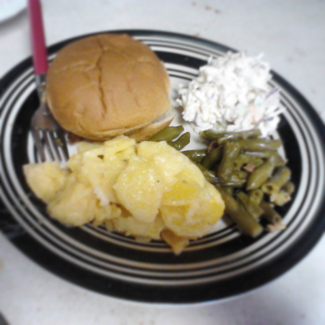 a plate with food containing potato and a hamburger on it