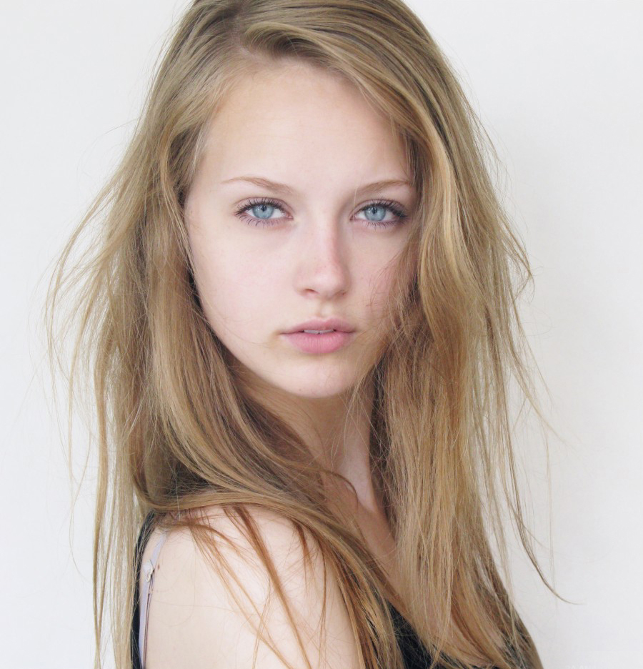 a close up of a woman with blue eyes