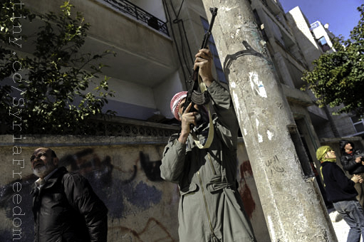 a man is holding an animal in his hand on a post