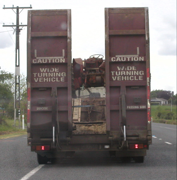 large transport truck with two trailers in rear
