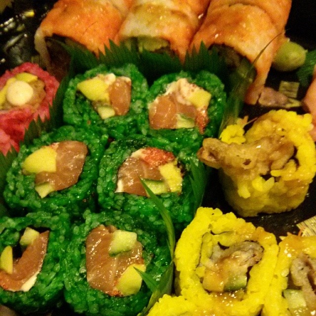 a plate has sushi in it with other foods