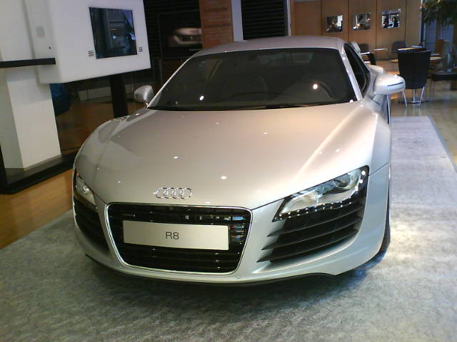 the silver car sits on display in a showroom