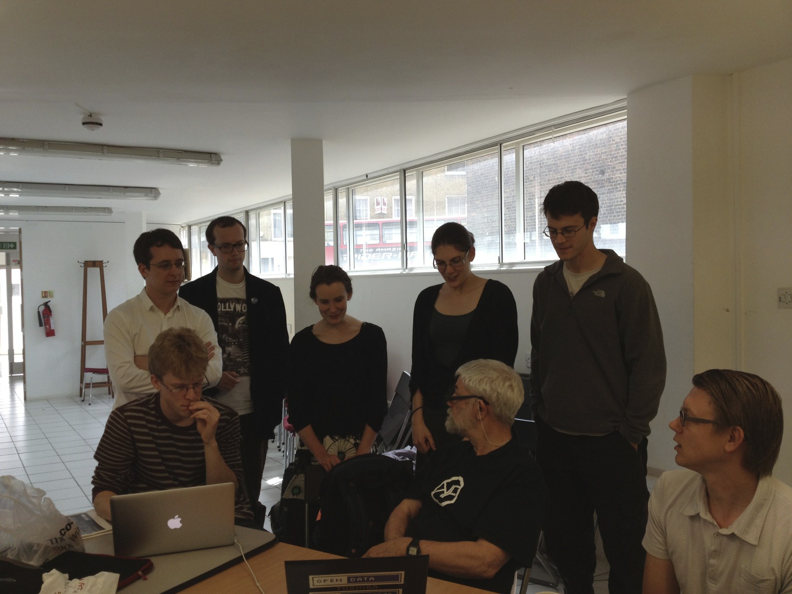 a group of people that are standing around some boxes