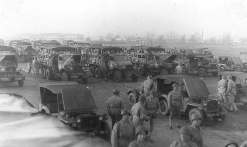 a vintage pograph shows many vehicles at a fair