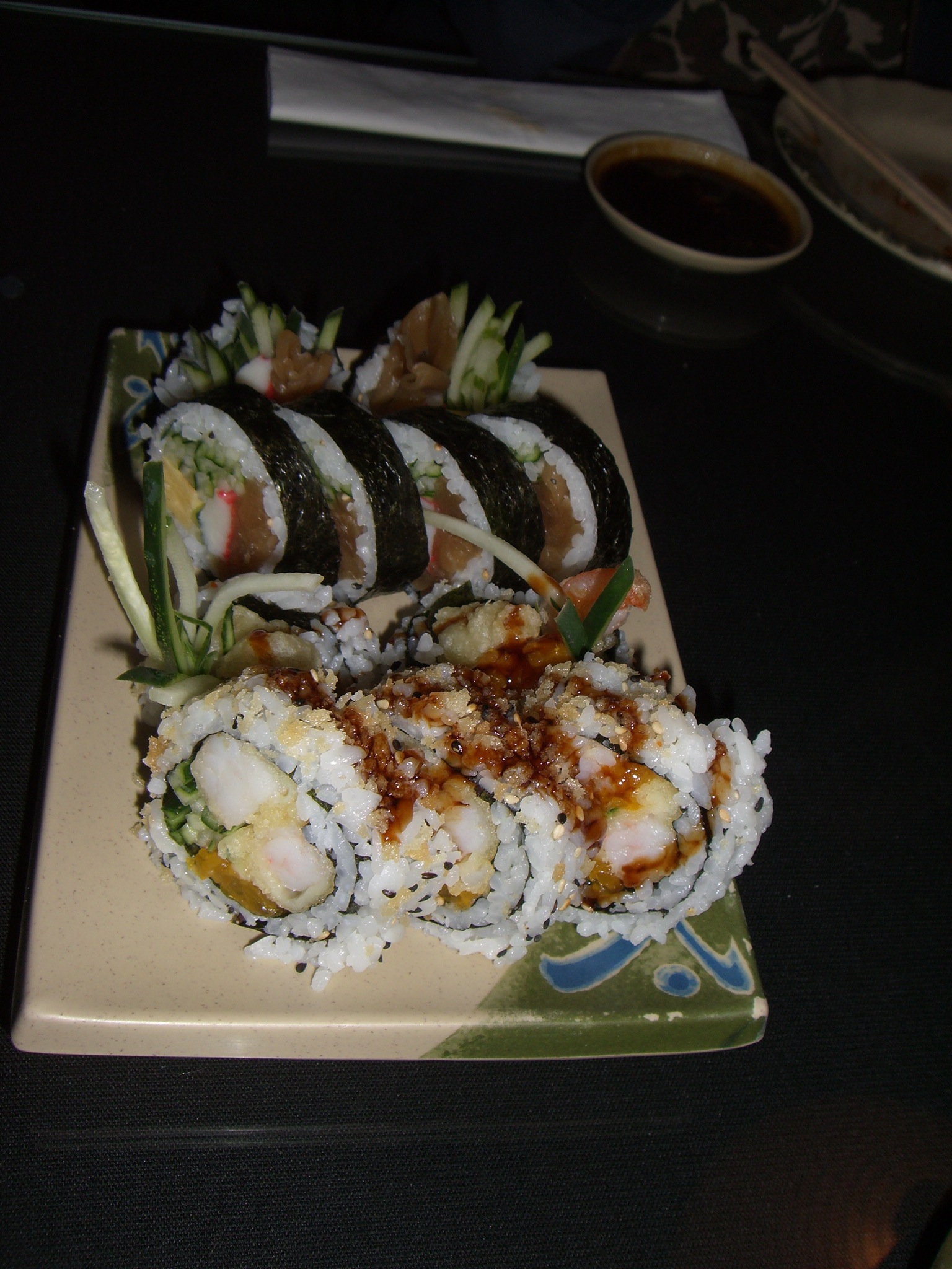 sushi dishes sit on a plate ready to be eaten