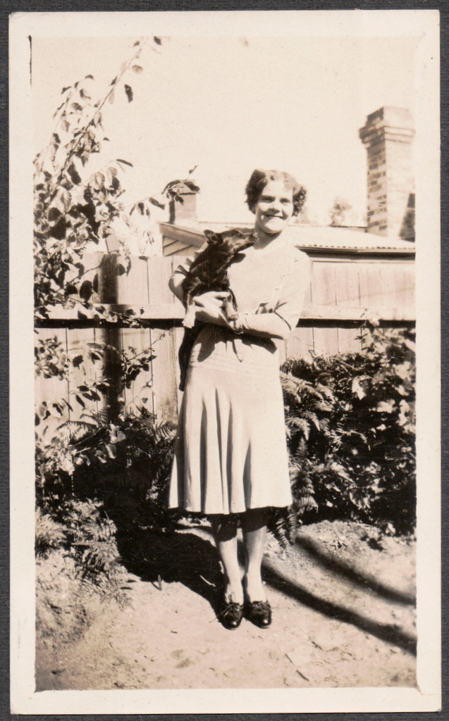 an old black and white po shows a young woman holding a cat