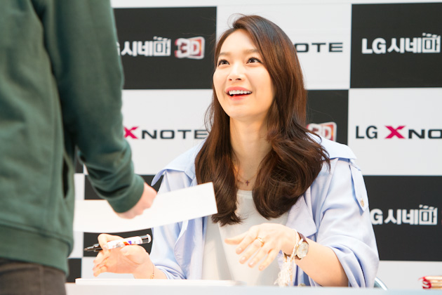 a woman is smiling as she holds her hand out to another person