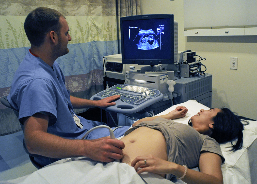 a nurse examines an umbilscope in a pregnant woman