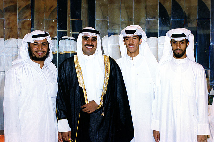 men in arab dress stand next to each other