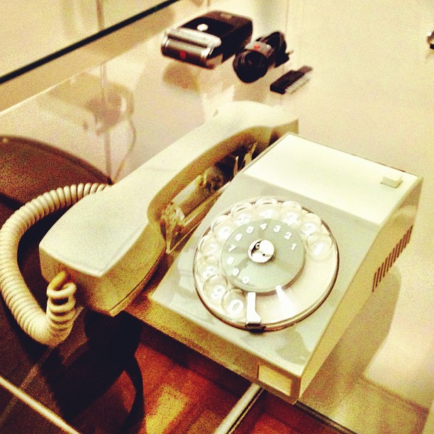 an old fashioned style telephone sitting on top of a counter