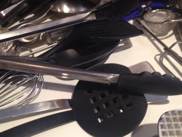 a kitchen scene complete with stainless steel utensils