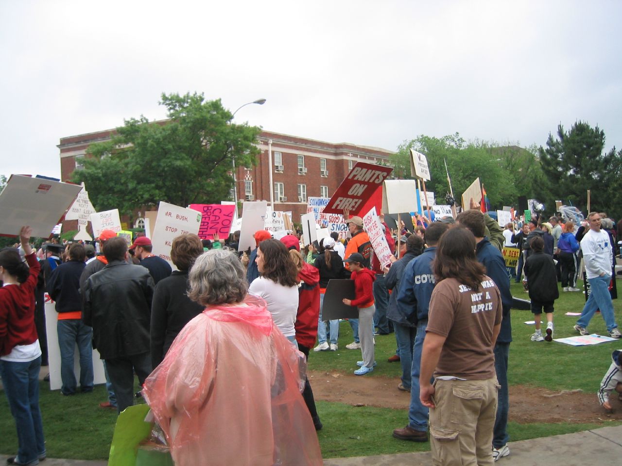 people standing outside holding signs and signs