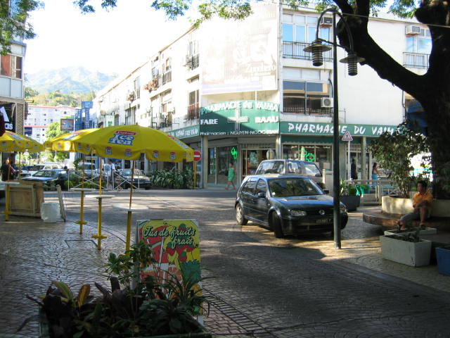 a car parked in front of a restaurant on a city street