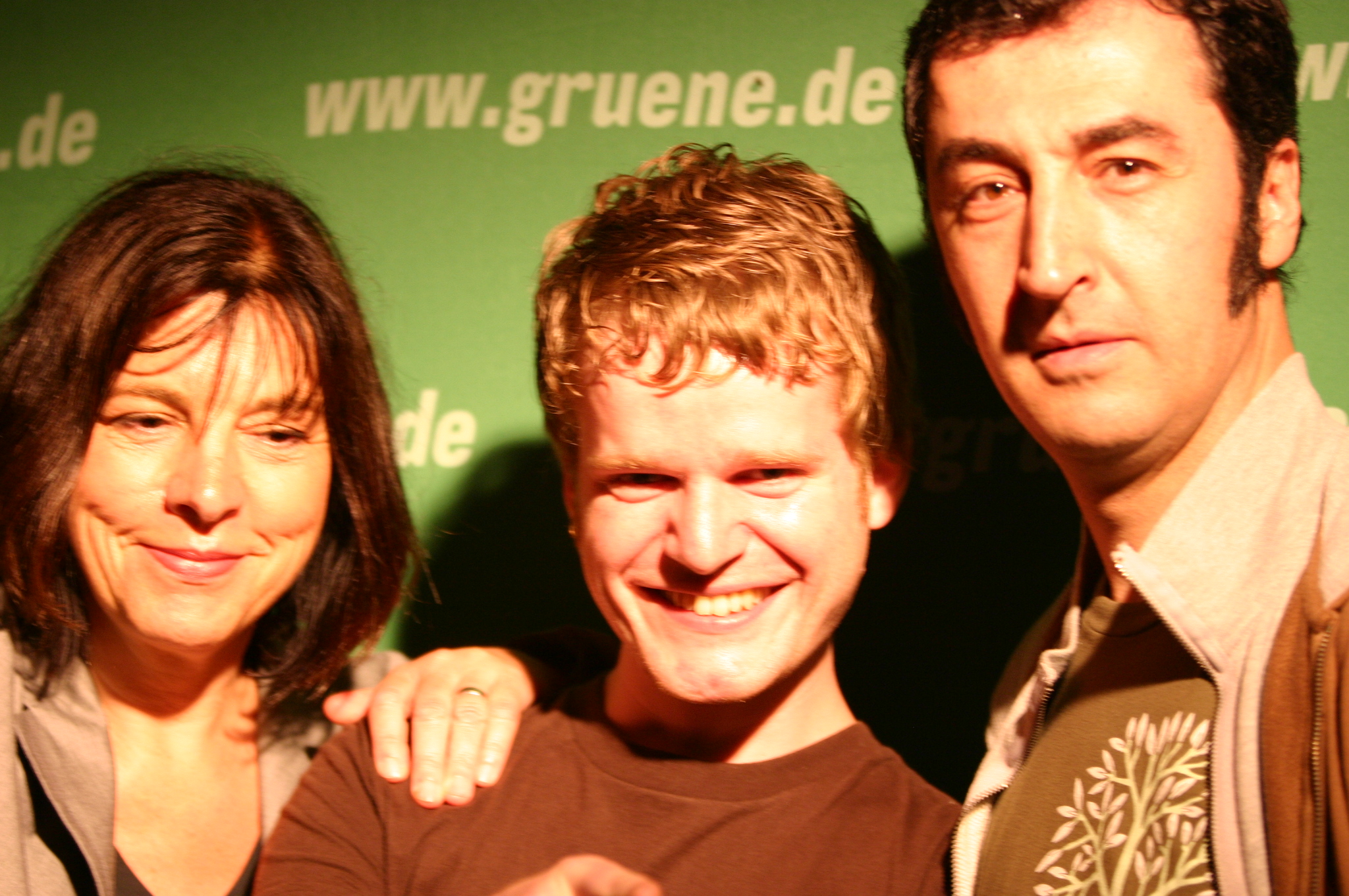 two men and a woman are posing for a picture