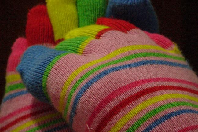 a colorful socks that is laying on a bed