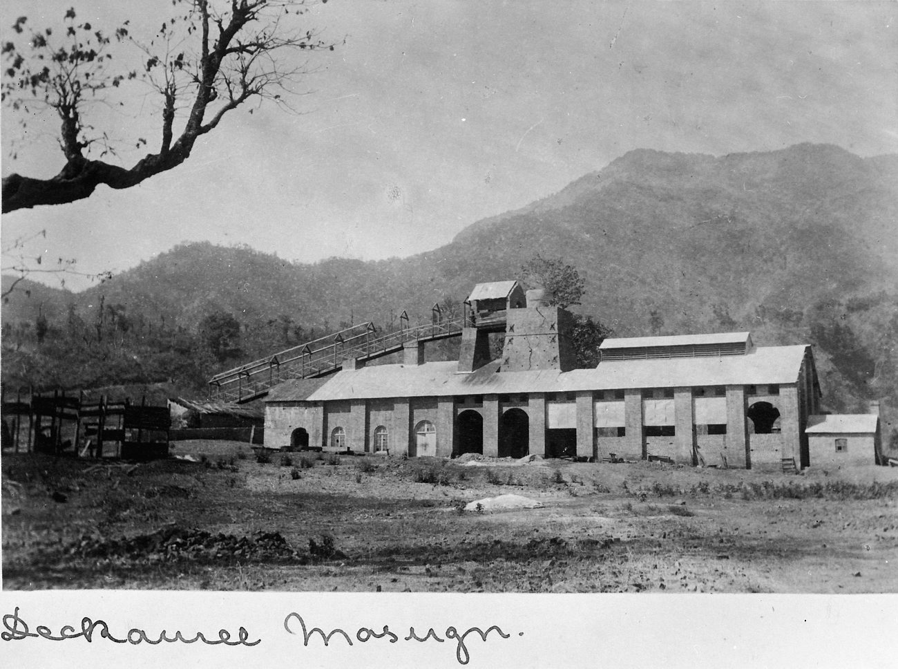 an old building surrounded by trees near mountains