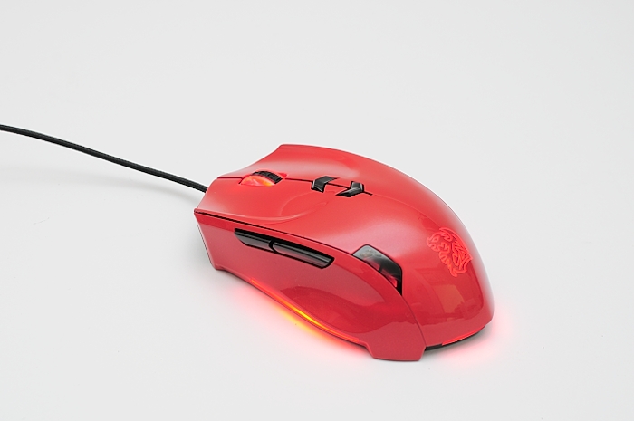 red computer mouse with black cord on white surface