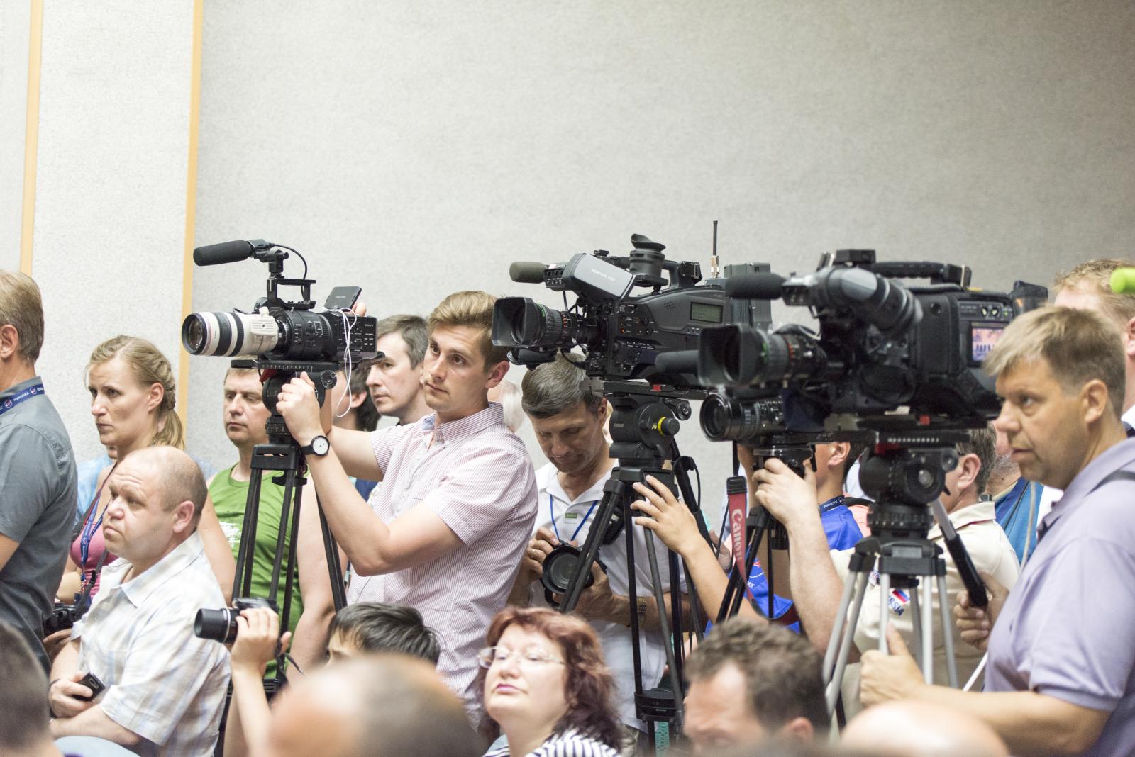 a group of people with cameras around them