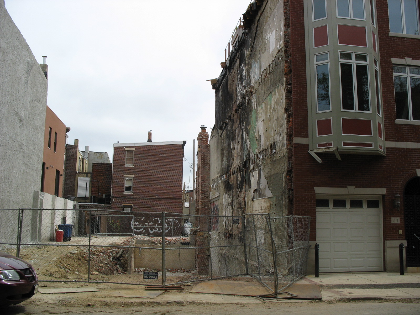 a building that is very damaged next to a fence