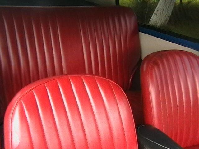 a set of four red seats and a black seat in a car