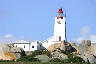 a light house sitting on top of some rocks