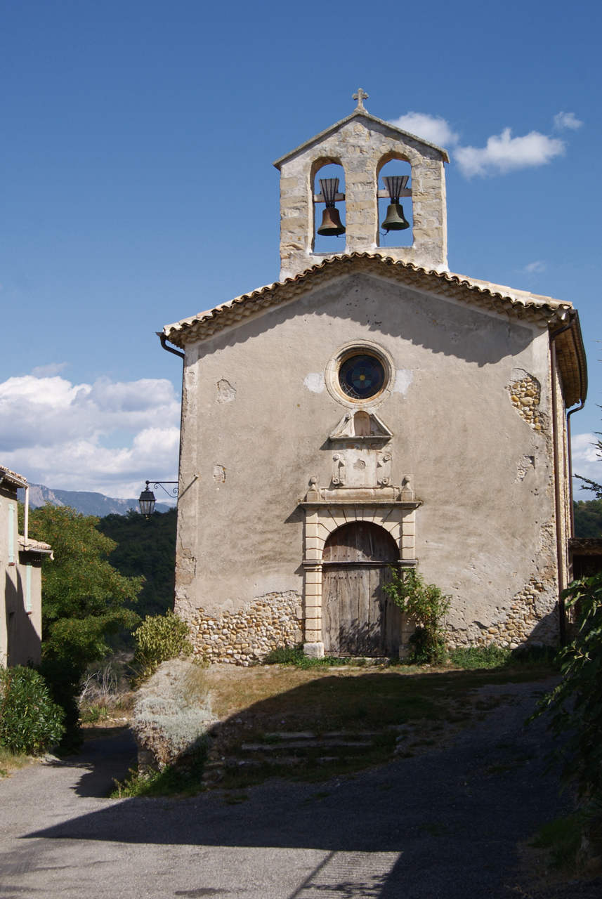 an old church with bells in the front