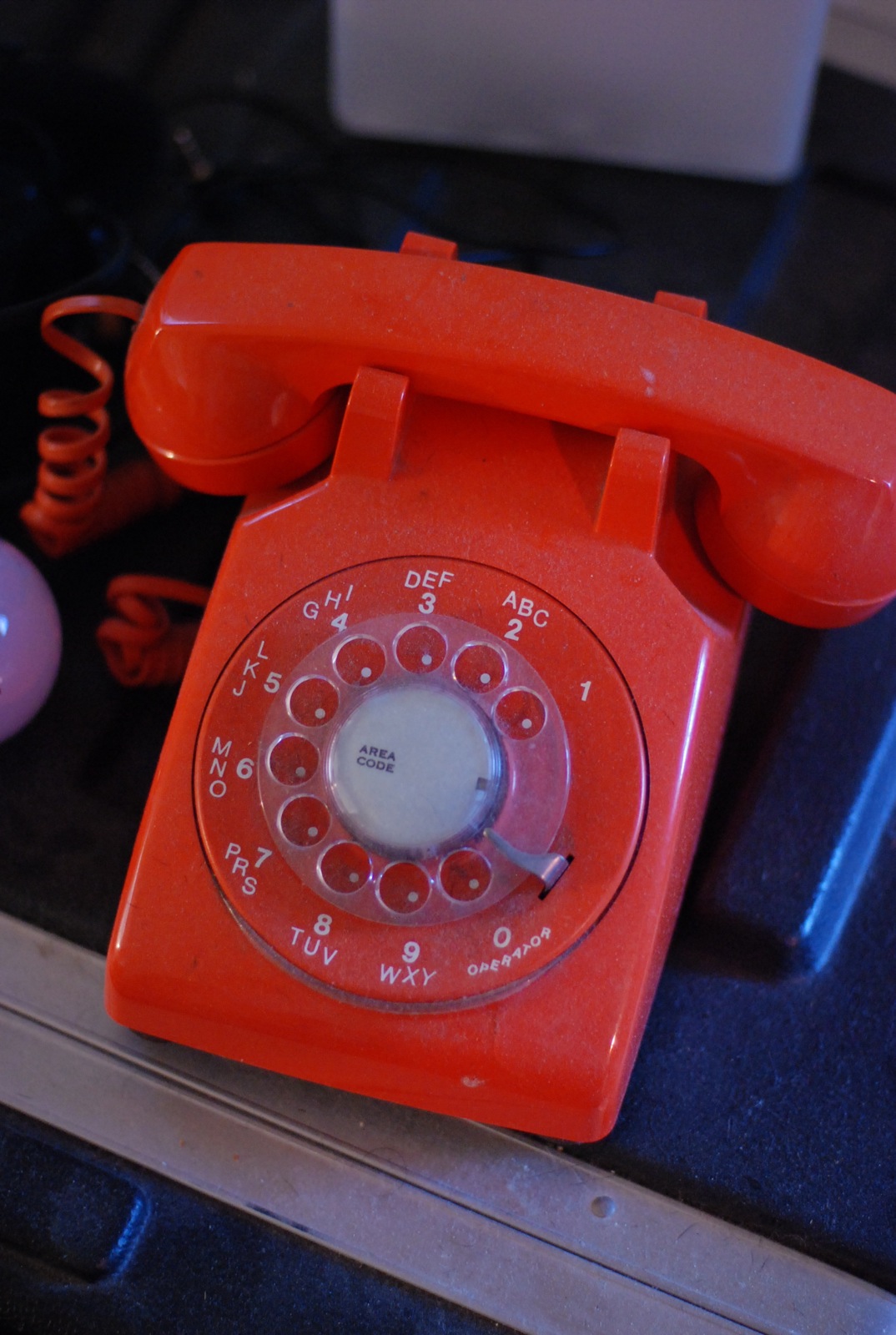 an old fashioned red phone sits on the table